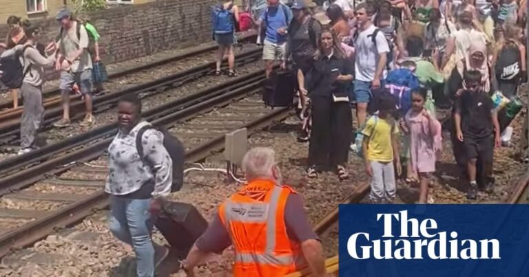 Evacuated London train passengers forced to walk along tracks on hottest day of year | Rail transport