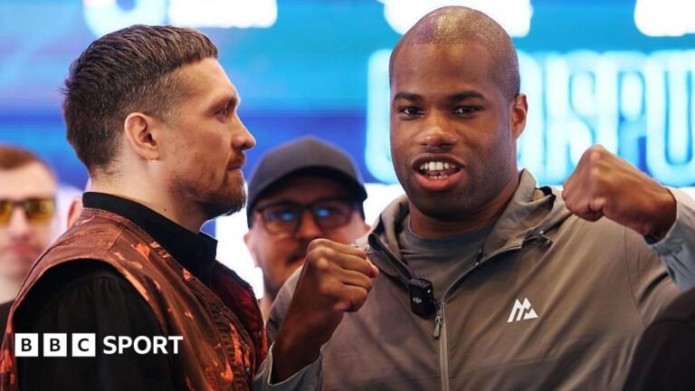 Oleksandr Usyk stares at Daniel Dubois, who breaks the face-off and flexes